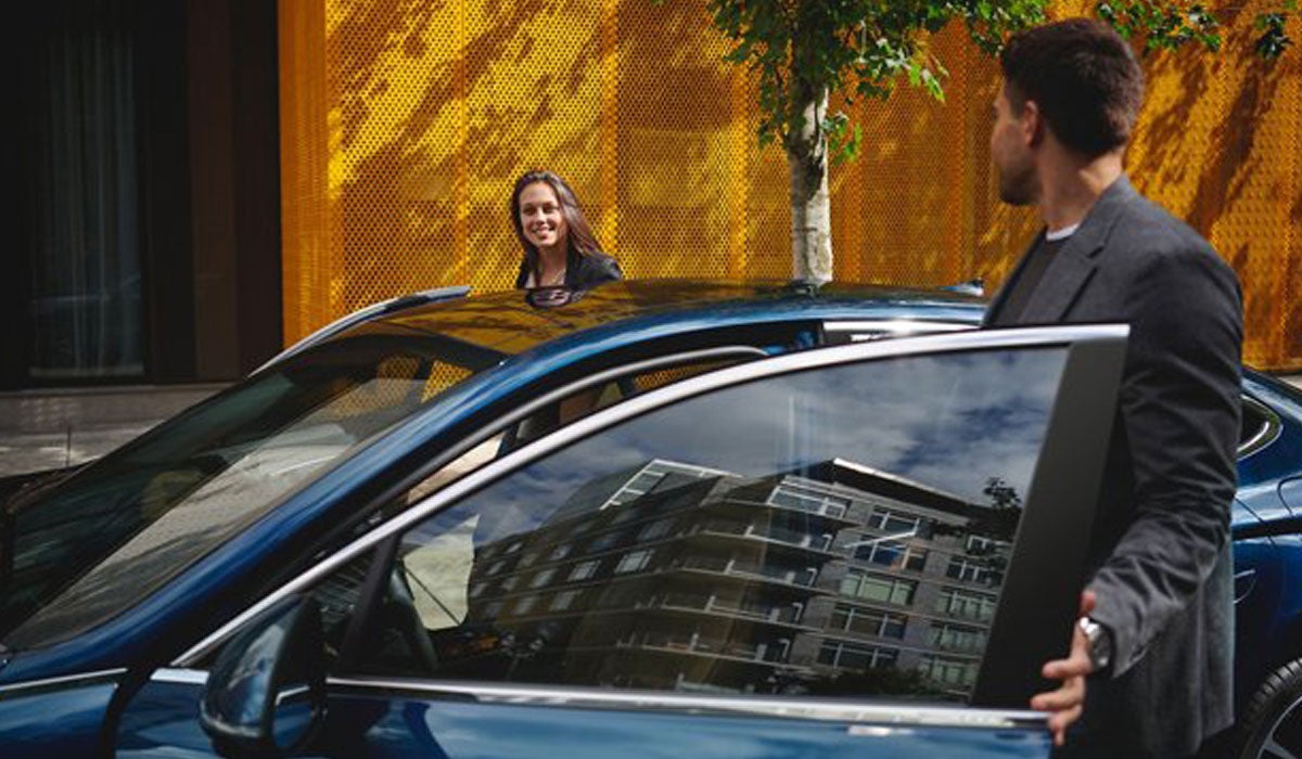 Two women entering a Hyundai sedan