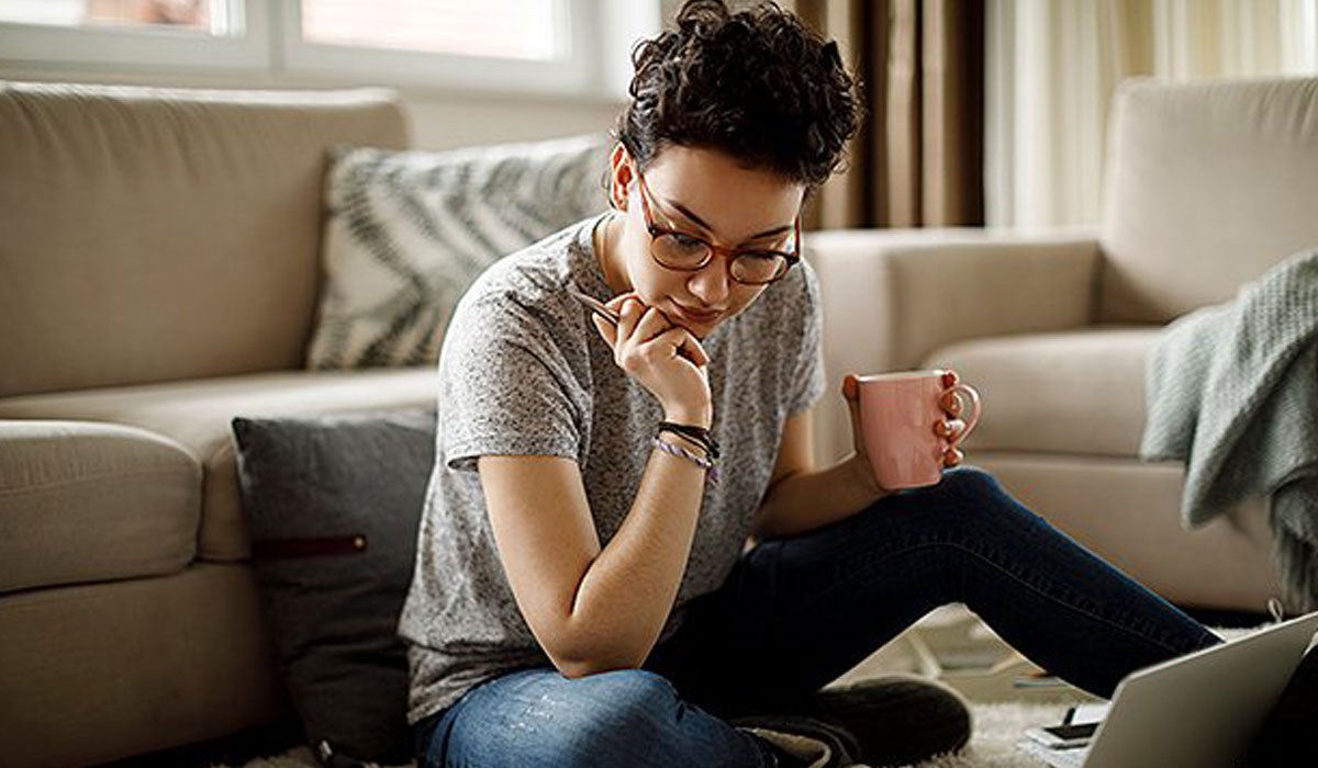 Woman car shopping on laptop